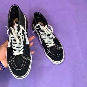 Black and white high top vans